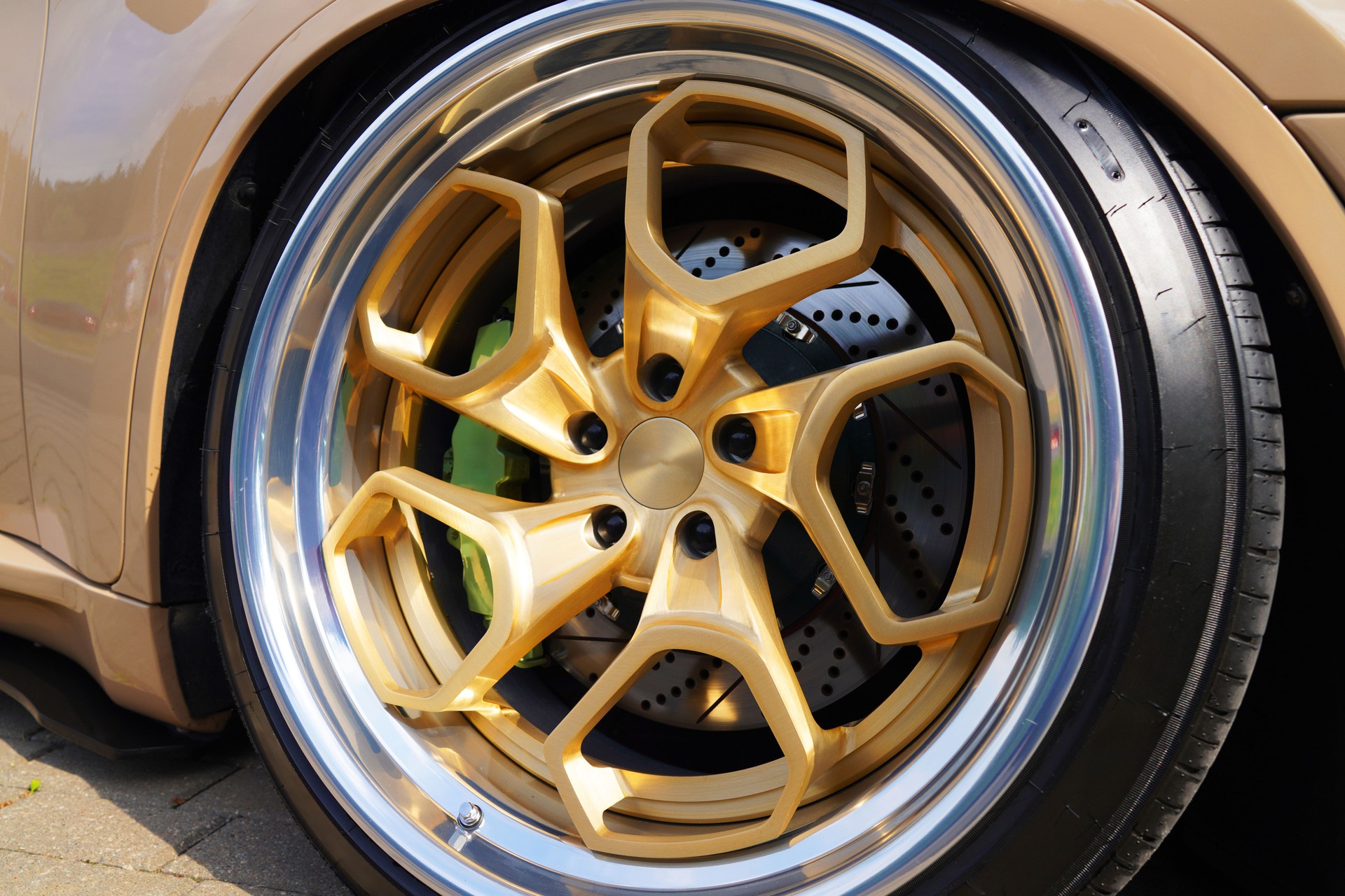 Alloy wheel with calipers and racing brakes of the sport car. Racing brake disc and low profile tyres.